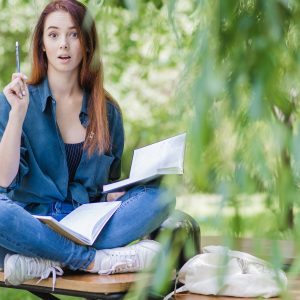 woman-with-notebooks-park